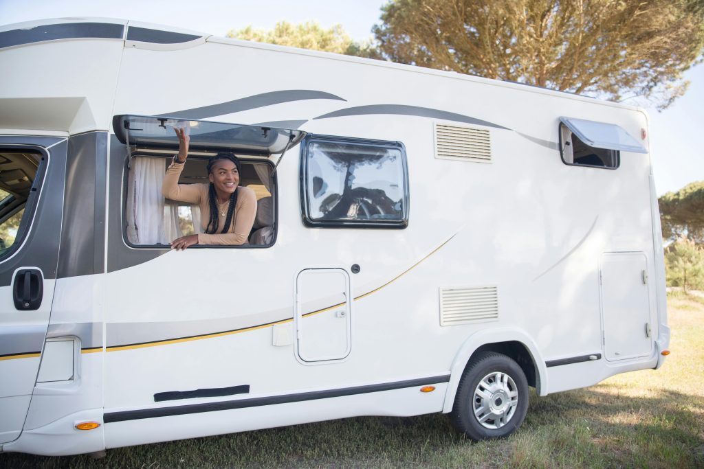 A Woman Sitting Beside the Caravan Window